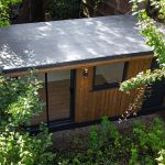 ClassicBond EPDM rubber roof on a timber clad garden room with grey aluminium edge trim