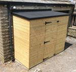 Skyguard EPDM rubber roof covering on a timber pent shed beside a stone wall